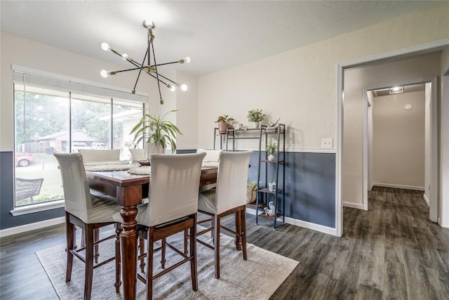 2416 Northwood Ln, Edmond, OK 73013 - dining space featuring a chandelier, dark wood-type flooring, and baseboards