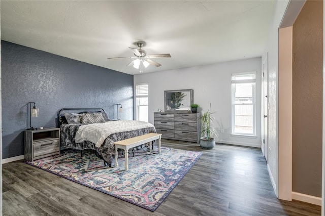 2416 Northwood Ln, Edmond, OK 73013 - bedroom featuring a textured wall, wood finished floors, and baseboards