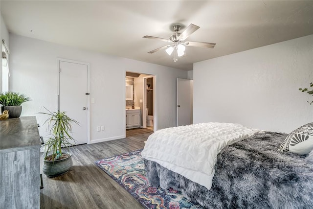 2416 Northwood Ln, Edmond, OK 73013 - bedroom with wood finished floors, baseboards, connected bathroom, and ceiling fan