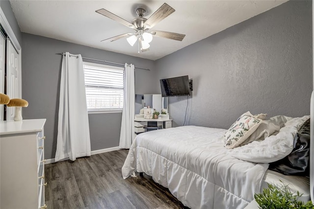 2416 Northwood Ln, Edmond, OK 73013 - bedroom with wood finished floors, a closet, ceiling fan, baseboards, and a textured wall