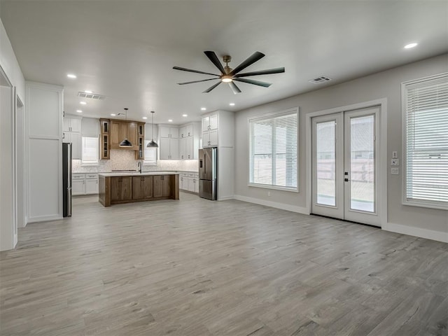 6305 NW 153rd St, Edmond, OK 73013 - kitchen featuring stainless steel fridge with ice dispenser, freestanding refrigerator, open floor plan, ceiling fan, and light countertops