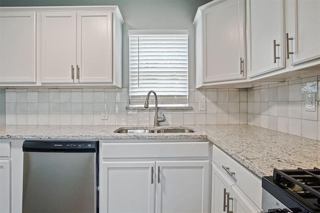 417 Russell Dr, Midwest City, OK 73110 - kitchen with appliances with stainless steel finishes, a sink, white cabinetry, and tasteful backsplash