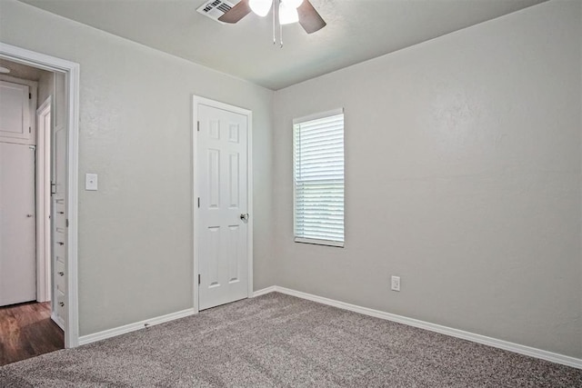 417 Russell Dr, Midwest City, OK 73110 - unfurnished bedroom with carpet flooring, baseboards, and ceiling fan