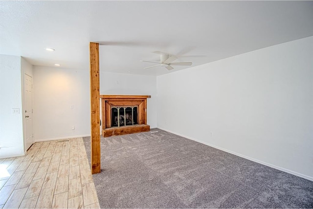 400 Timberwind Rd, Edmond, OK 73034 - unfurnished living room featuring a ceiling fan, a fireplace with raised hearth, baseboards, and recessed lighting