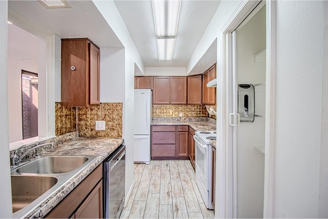 400 Timberwind Rd, Edmond, OK 73034 - kitchen featuring white appliances, a sink, decorative backsplash, brown cabinets, and light wood-style floors