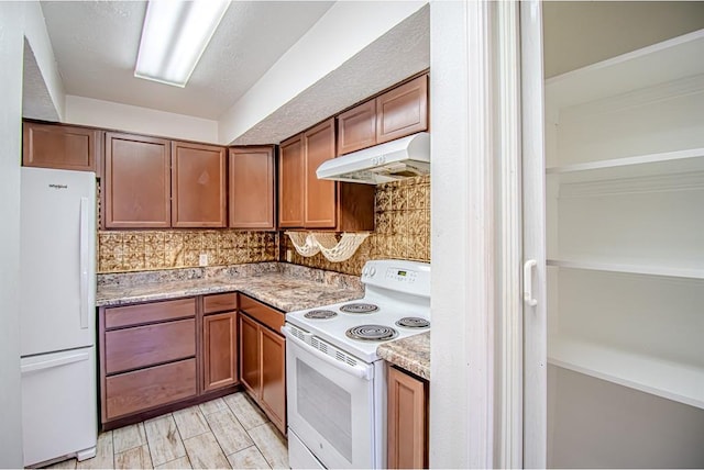 400 Timberwind Rd, Edmond, OK 73034 - kitchen featuring white appliances, under cabinet range hood, backsplash, and brown cabinetry
