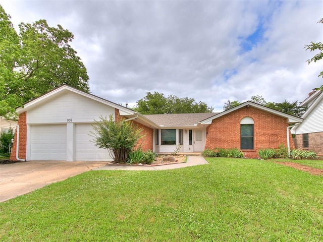 909 Schulze Dr, Norman, OK 73071 - ranch-style house featuring brick siding, a garage, a front lawn, and driveway