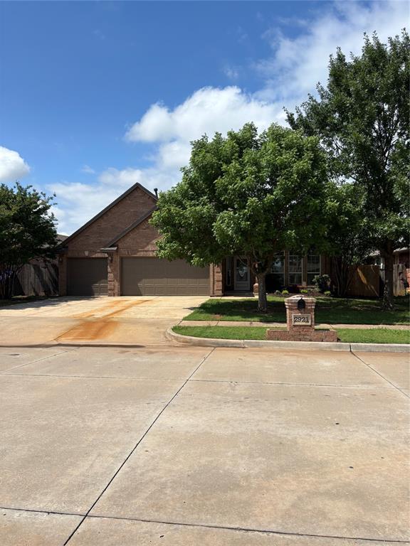 2921 Summit Crossing Pkwy, Norman, OK 73071 - view of front of home with driveway and a garage