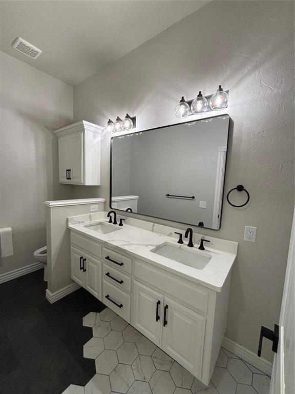 2921 Summit Crossing Pkwy, Norman, OK 73071 - full bathroom with toilet, double vanity, tile patterned floors, and baseboards