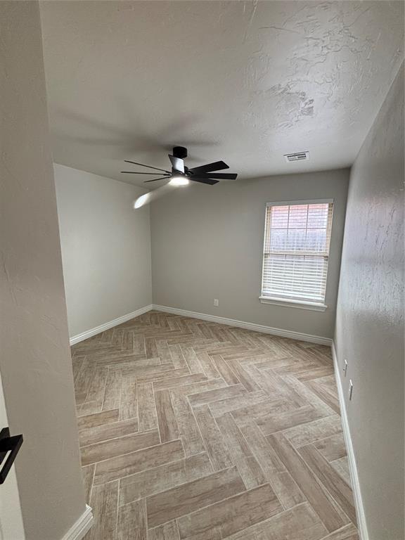 2921 Summit Crossing Pkwy, Norman, OK 73071 - empty room with baseboards and a ceiling fan