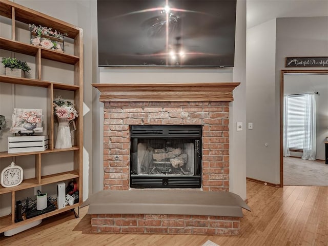 2120 NE 4th St, Moore, OK 73160 - detailed view of a fireplace, wood finished floors, and baseboards