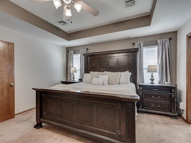 2120 NE 4th St, Moore, OK 73160 - bedroom with light colored carpet, a ceiling fan, baseboards, and a raised ceiling