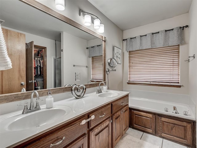2120 NE 4th St, Moore, OK 73160 - full bath featuring double vanity, tile patterned floors, a bath, a spacious closet, and a shower with shower door