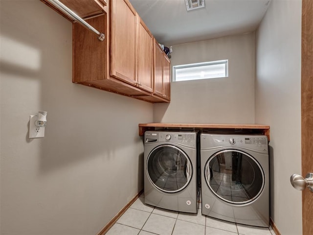 2120 NE 4th St, Moore, OK 73160 - washroom featuring washing machine and dryer, light tile patterned flooring, cabinet space, and baseboards