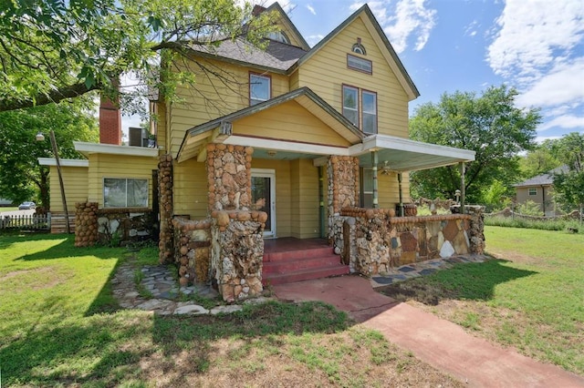 624 N Wentz St, Guthrie, OK 73044 - view of front of home with a porch, a front lawn, a chimney, and stone siding