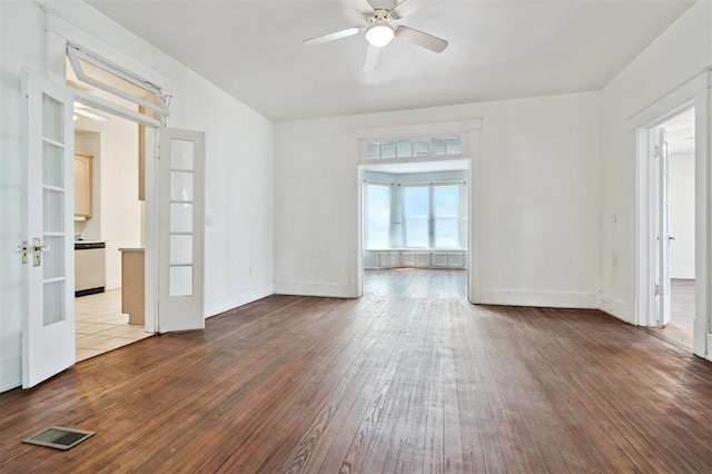 624 N Wentz St, Guthrie, OK 73044 - spare room with hardwood / wood-style flooring, ceiling fan, baseboards, and french doors
