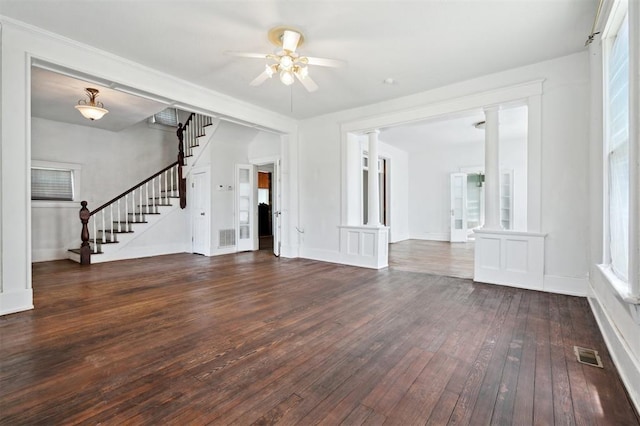 624 N Wentz St, Guthrie, OK 73044 - unfurnished living room featuring hardwood / wood-style floors, stairway, ceiling fan, decorative columns, and baseboards