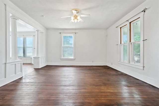 624 N Wentz St, Guthrie, OK 73044 - spare room with a ceiling fan, dark wood-type flooring, ornate columns, and baseboards