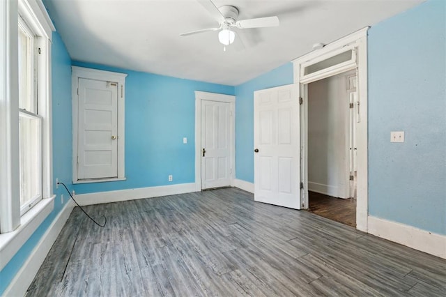 624 N Wentz St, Guthrie, OK 73044 - unfurnished bedroom with wood finished floors, baseboards, a closet, and a ceiling fan