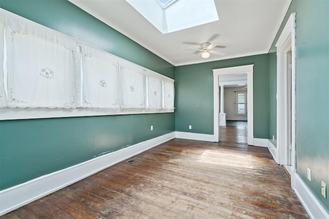 624 N Wentz St, Guthrie, OK 73044 - empty room with a skylight, wood finished floors, crown molding, a ceiling fan, and baseboards
