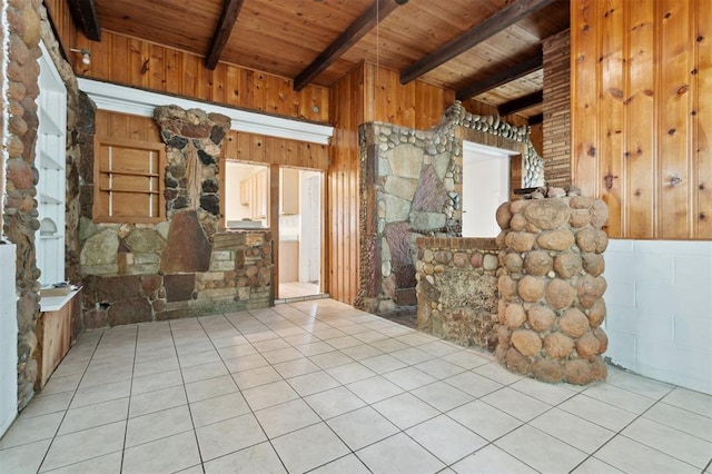 624 N Wentz St, Guthrie, OK 73044 - unfurnished living room featuring wooden ceiling with exposed beams, wood walls, and tile patterned floors