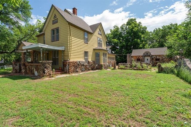 624 N Wentz St, Guthrie, OK 73044 - rear view of house featuring a lawn, a porch, a chimney, and stone siding