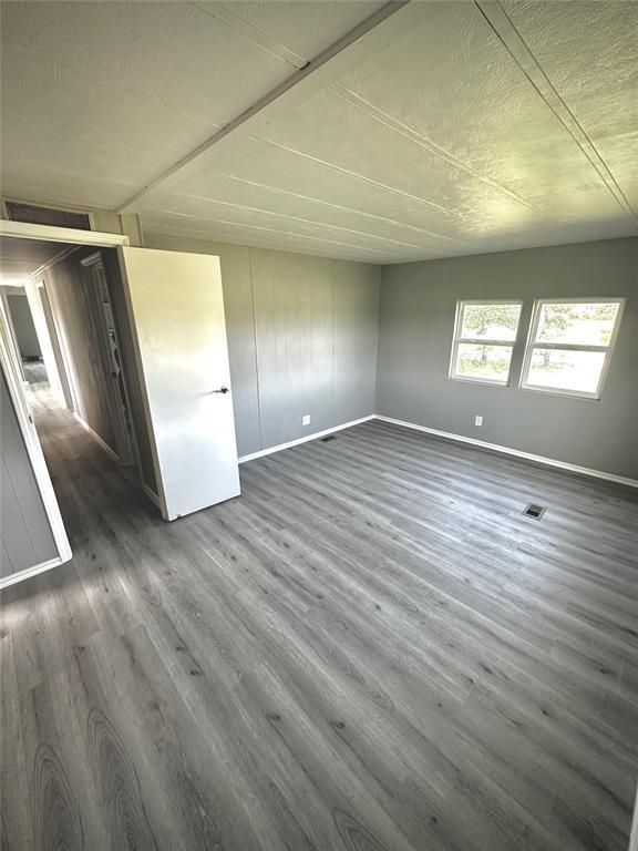 101869 S 3570th Rd, Prague, OK 74864 - empty room with baseboards and dark wood-style floors