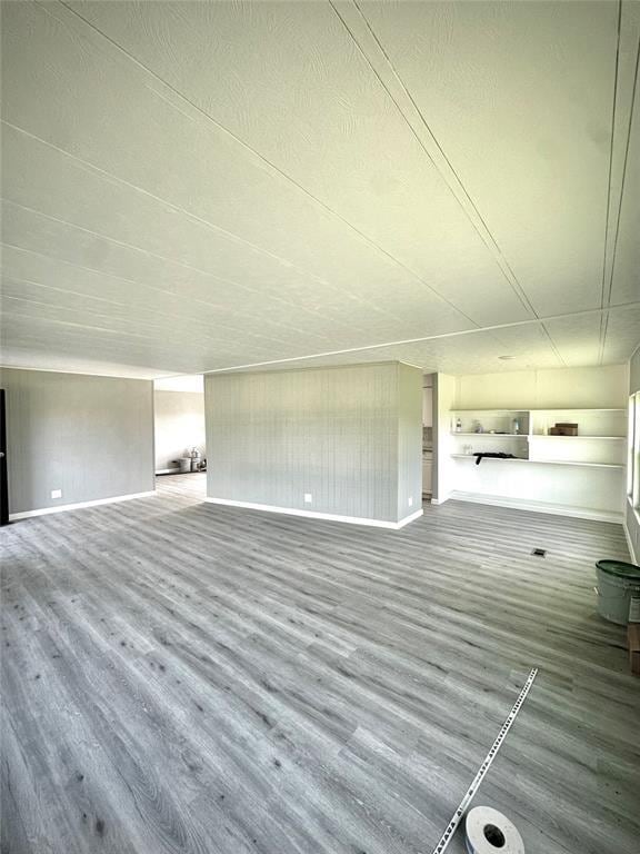 101869 S 3570th Rd, Prague, OK 74864 - unfurnished living room featuring wood finished floors and baseboards