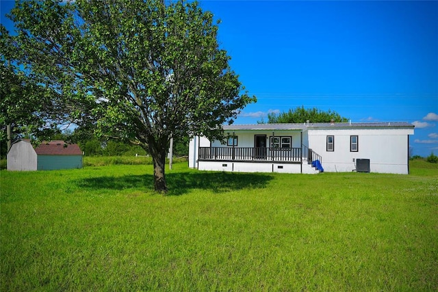 101869 S 3570th Rd, Prague, OK 74864 - rear view of house featuring central AC unit, a yard, and covered porch