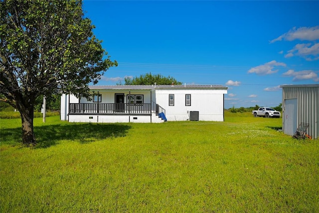 101869 S 3570th Rd, Prague, OK 74864 - back of house with a lawn, cooling unit, and covered porch