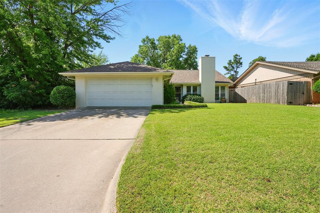6608 Fawn Canyon Dr, Oklahoma City, OK 73162 - ranch-style house with a chimney, concrete driveway, and an attached garage