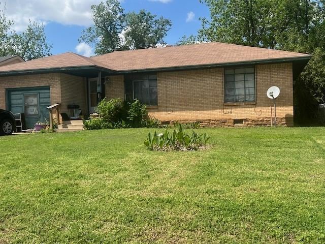 1401 NE 37th St, Oklahoma City, OK 73111 - back of property featuring brick siding, a lawn, and crawl space