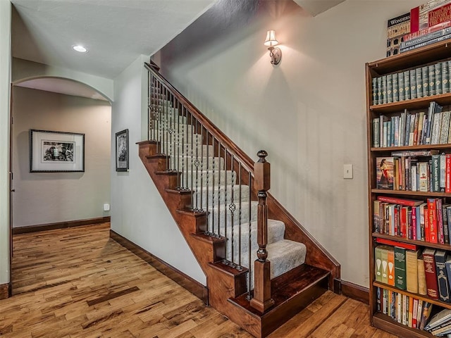 19401 N Peebly Rd, Luther, OK 73054 - stairs featuring arched walkways, wood finished floors, baseboards, and recessed lighting