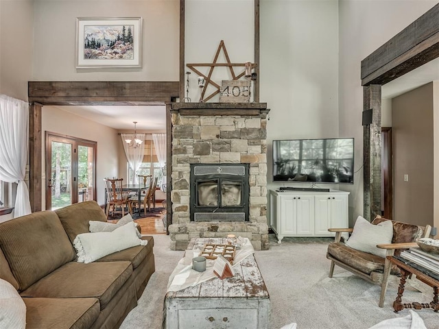 19401 N Peebly Rd, Luther, OK 73054 - living area with carpet floors, a high ceiling, a chandelier, and a stone fireplace