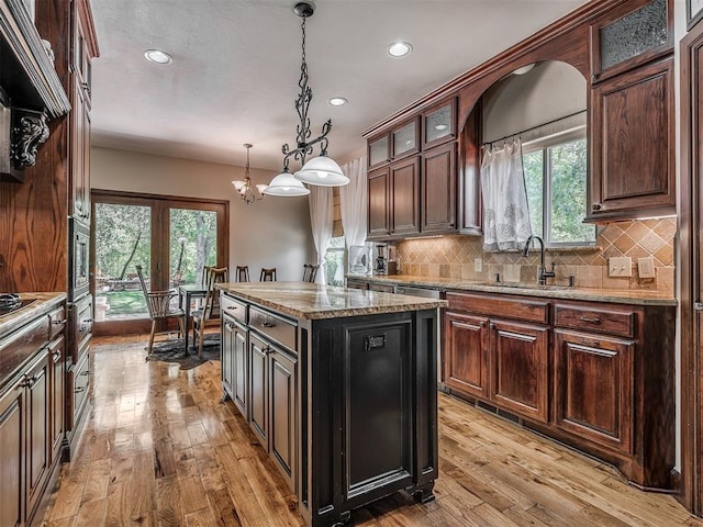 19401 N Peebly Rd, Luther, OK 73054 - kitchen with a sink, recessed lighting, light wood-type flooring, decorative backsplash, and plenty of natural light