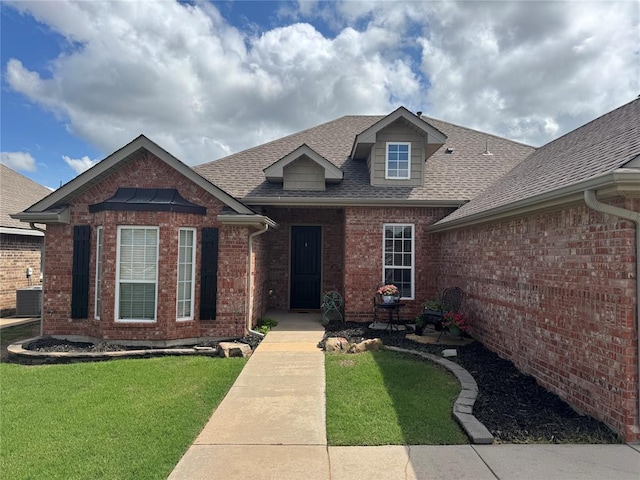 1912 SE 18th St, Moore, OK 73160 - view of front of property featuring roof with shingles, brick siding, a front lawn, and central AC unit
