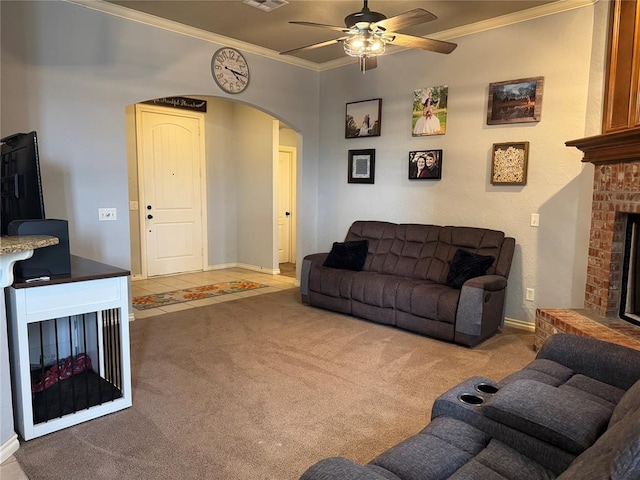 1912 SE 18th St, Moore, OK 73160 - living area with a fireplace, arched walkways, ornamental molding, ceiling fan, and carpet flooring