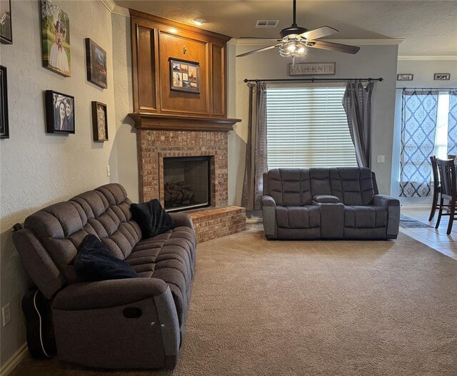 1912 SE 18th St, Moore, OK 73160 - carpeted living area with ceiling fan, a brick fireplace, crown molding, and a textured wall