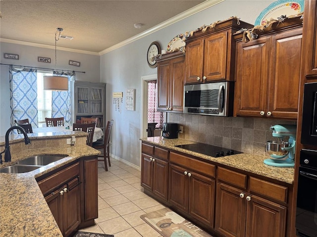 1912 SE 18th St, Moore, OK 73160 - kitchen featuring black appliances, a sink, tasteful backsplash, light tile patterned floors, and hanging light fixtures