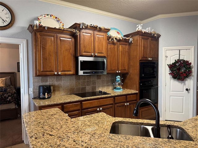 1912 SE 18th St, Moore, OK 73160 - kitchen with black appliances, a sink, crown molding, light stone countertops, and backsplash