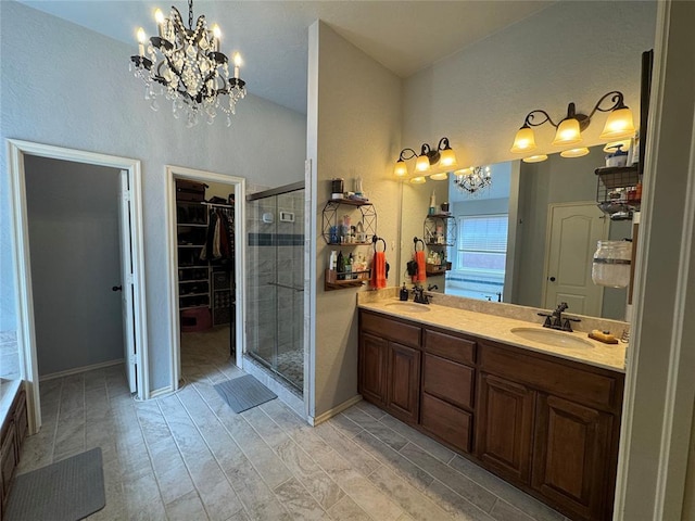 1912 SE 18th St, Moore, OK 73160 - full bath with a chandelier, a shower stall, double vanity, a spacious closet, and wood finished floors