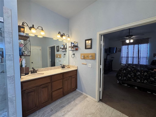 1912 SE 18th St, Moore, OK 73160 - bathroom with vaulted ceiling, double vanity, ceiling fan, baseboards, and a textured wall