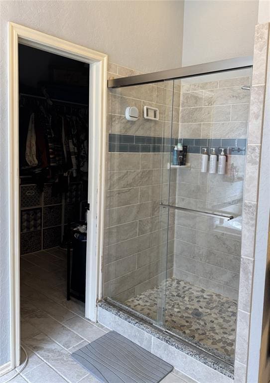 1912 SE 18th St, Moore, OK 73160 - bathroom featuring a shower stall, a walk in closet, and tile patterned flooring