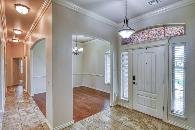 5524 SE 57th St, Oklahoma City, OK 73135 - foyer featuring arched walkways, ornamental molding, baseboards, and a chandelier