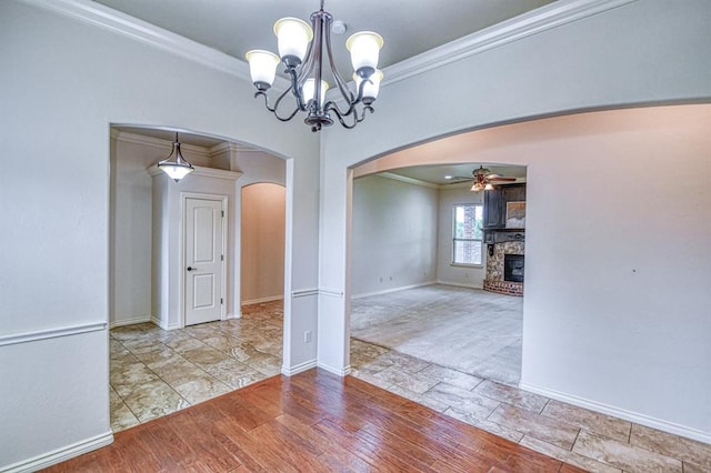 5524 SE 57th St, Oklahoma City, OK 73135 - unfurnished dining area with arched walkways, ornamental molding, a ceiling fan, baseboards, and a fireplace
