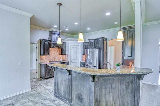 5524 SE 57th St, Oklahoma City, OK 73135 - kitchen with stainless steel fridge, a breakfast bar, tasteful backsplash, crown molding, and baseboards