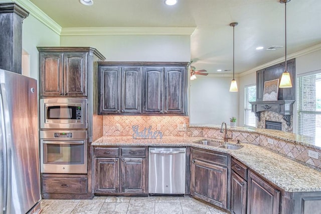 5524 SE 57th St, Oklahoma City, OK 73135 - kitchen featuring appliances with stainless steel finishes, a sink, light stone countertops, dark brown cabinets, and ornamental molding