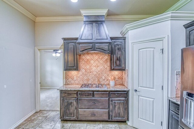 5524 SE 57th St, Oklahoma City, OK 73135 - kitchen with dark brown cabinetry, light stone countertops, tasteful backsplash, ornamental molding, and recessed lighting