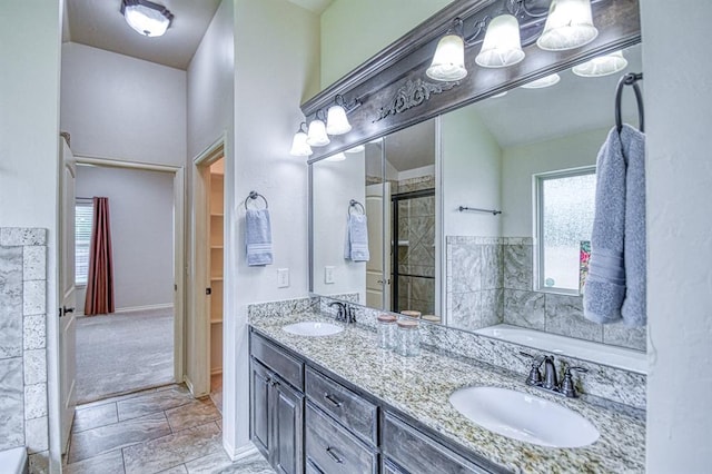 5524 SE 57th St, Oklahoma City, OK 73135 - full bathroom featuring a garden tub, double vanity, a tile shower, and baseboards