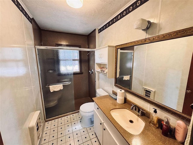 4443 Apperson Rd, Burbank, OK 74633 - bathroom with toilet, tile patterned floors, a stall shower, a textured ceiling, and vanity